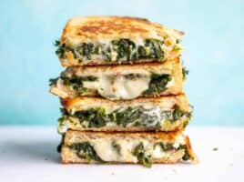 A stack of spinach and feta grilled cheese sandwiches