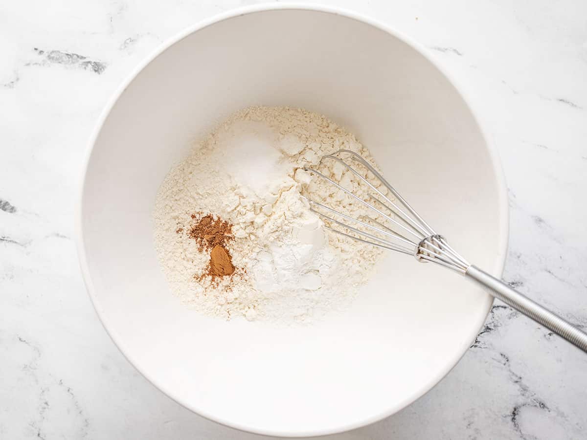 muffin dry ingredients in a bowl with a whisk.