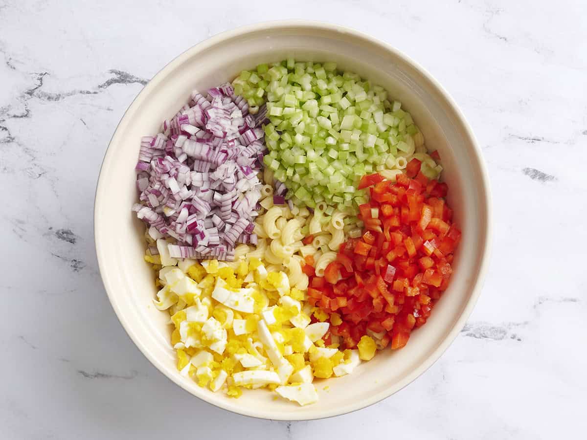 The ingredients for homemade macaroni salad in a bowl.