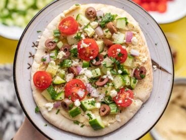 close up view of loaded hummus pita.