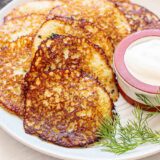 Close up side view of Deruny on a plate with sour cream.