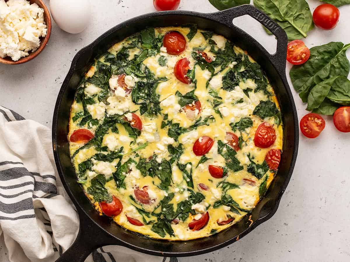 Overhead view of a spinach and tomato frittata