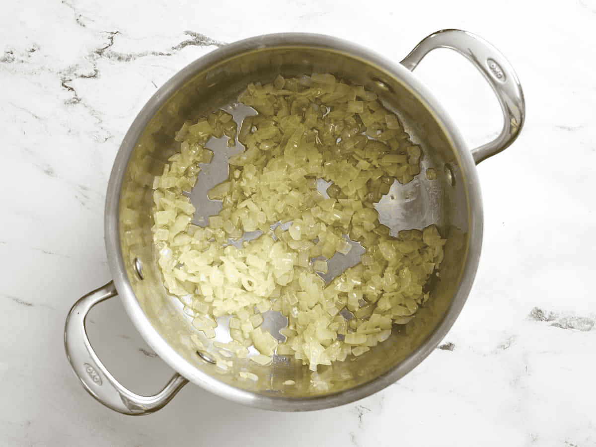 Sauteeing onions and garlic in a pot.