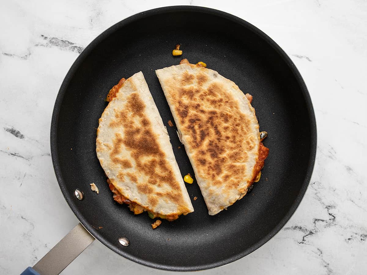 Cooked quesadillas in the skillet.
