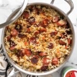 Overhead view of sausage and rice in the skillet.