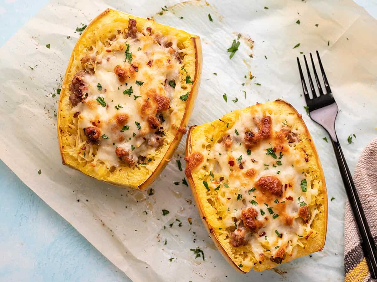 Overhead shot of stuffed spaghetti squash with a black fork next to it.