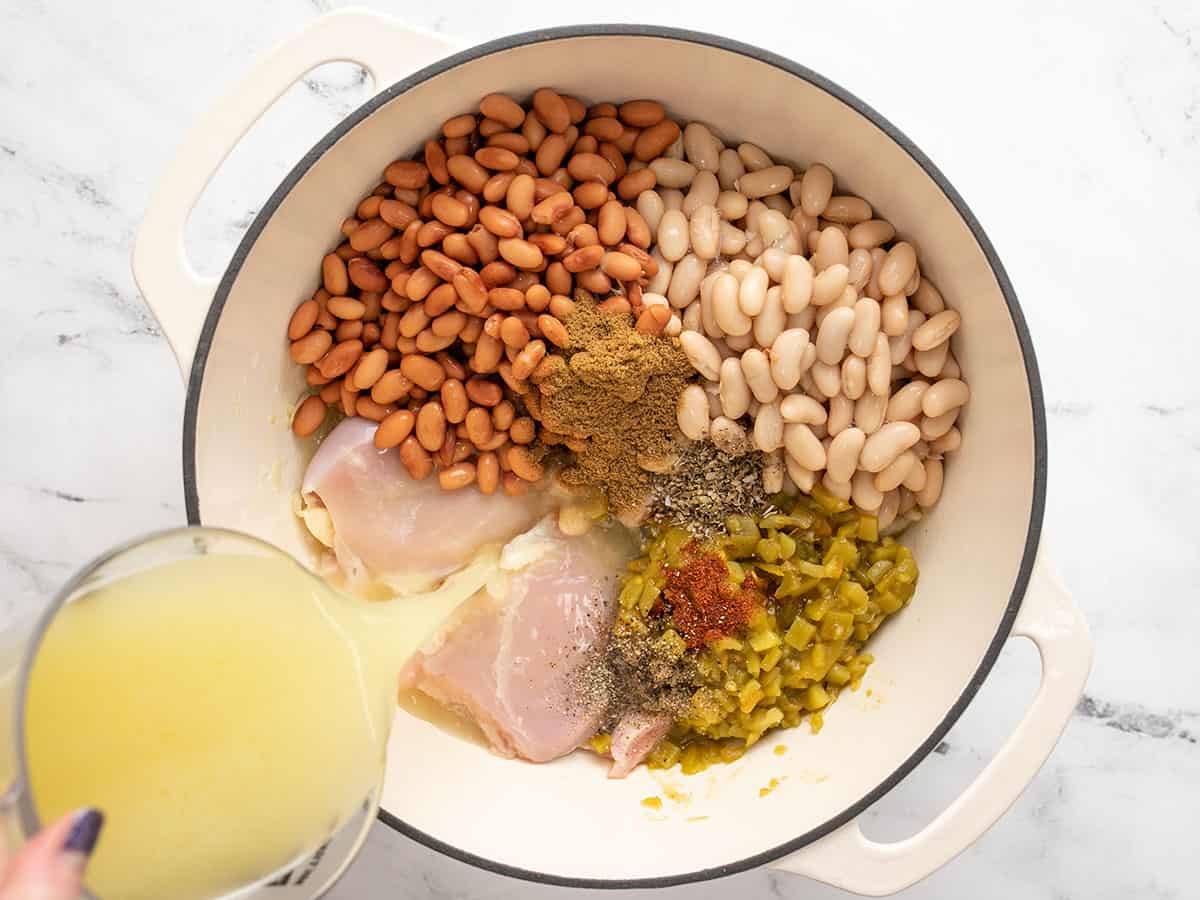 Chicken, beans, spices, and broth added to the pot.