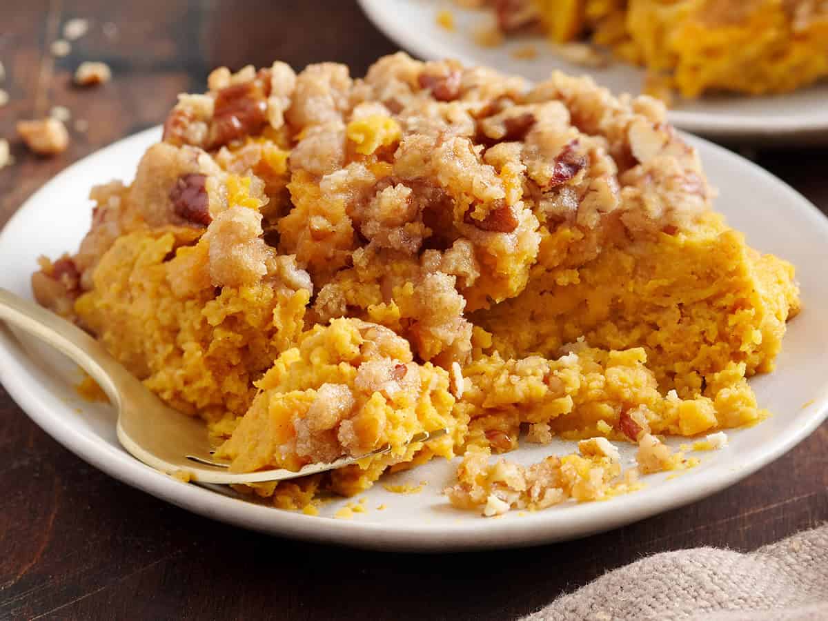 Sweet potato casserole on a plate with a fork.
