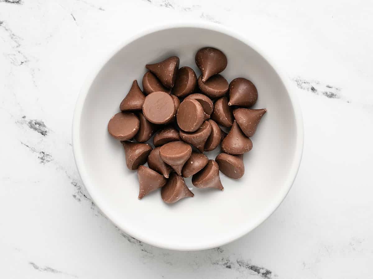 Unwrapped Hershey's kisses in a bowl.