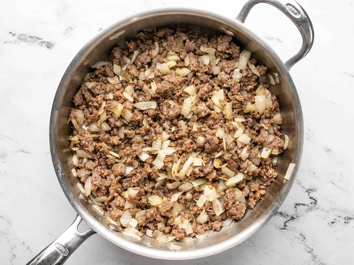 Browned sausage and onions in a deep skillet.