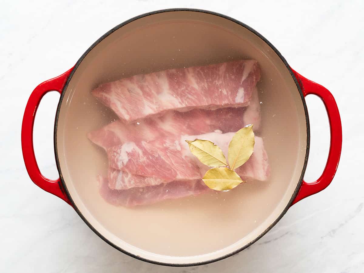 Pork ribs and bay leave in a large pot.