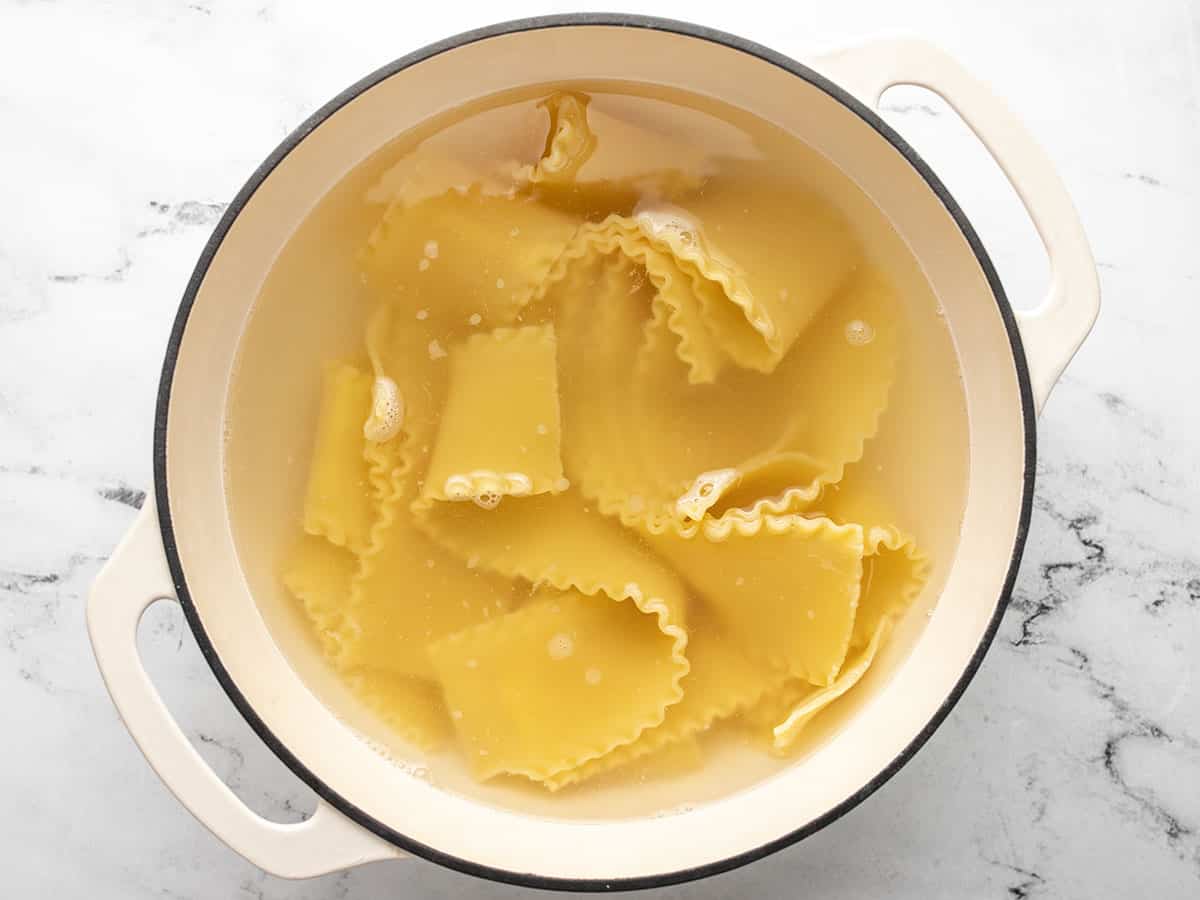 Boiled lasagna noodles in a Dutch oven.