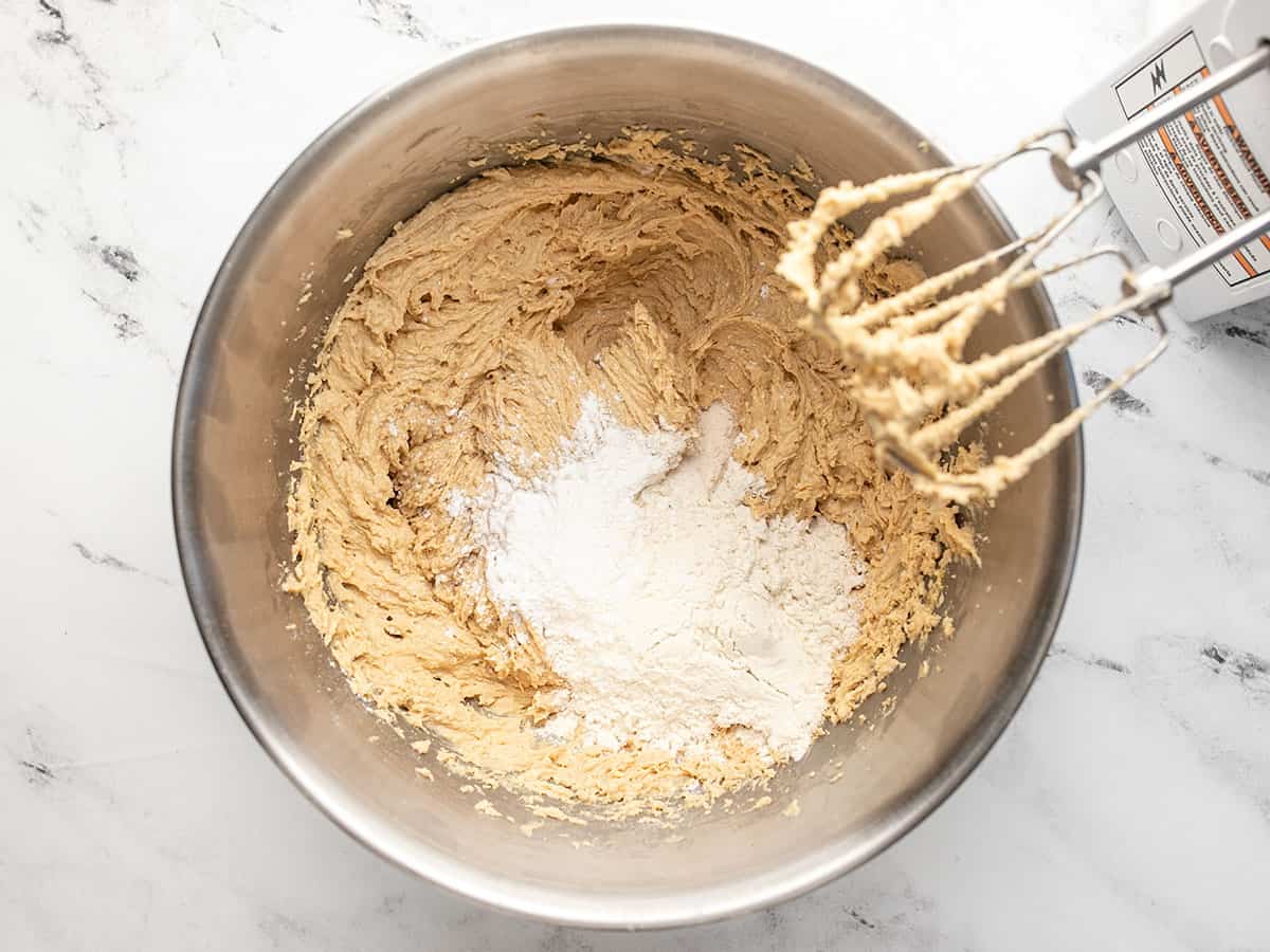 Dry ingredients added to the batter in the bowl.