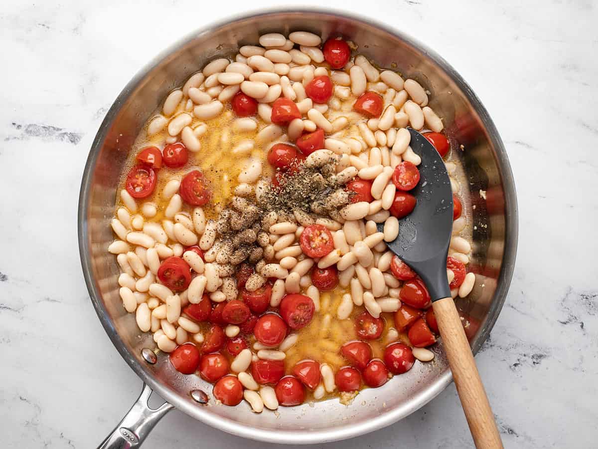 Herbs and water added to the skillet.