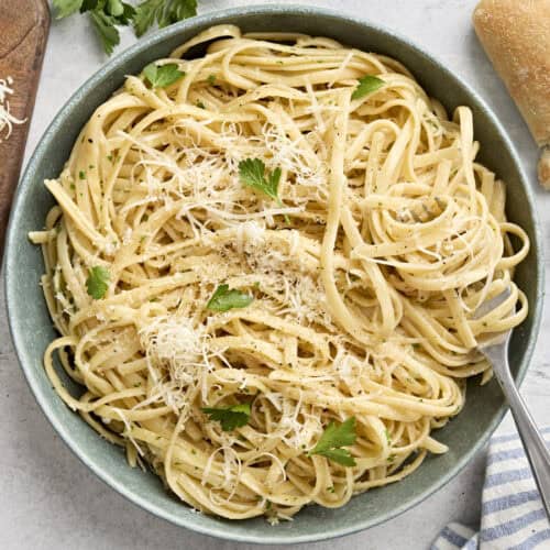 Overhead view of a plate of fettuccine alfredo with a fork.