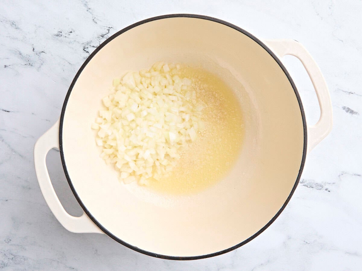 Diced onion and melted butter in a Dutch oven.