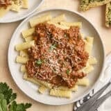 Overhead view of a plate of bolognese sauce and pasta.