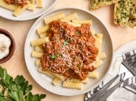 Overhead view of a plate of bolognese sauce and pasta.