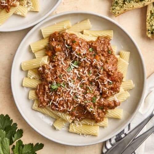 Overhead view of a plate of bolognese sauce and pasta.