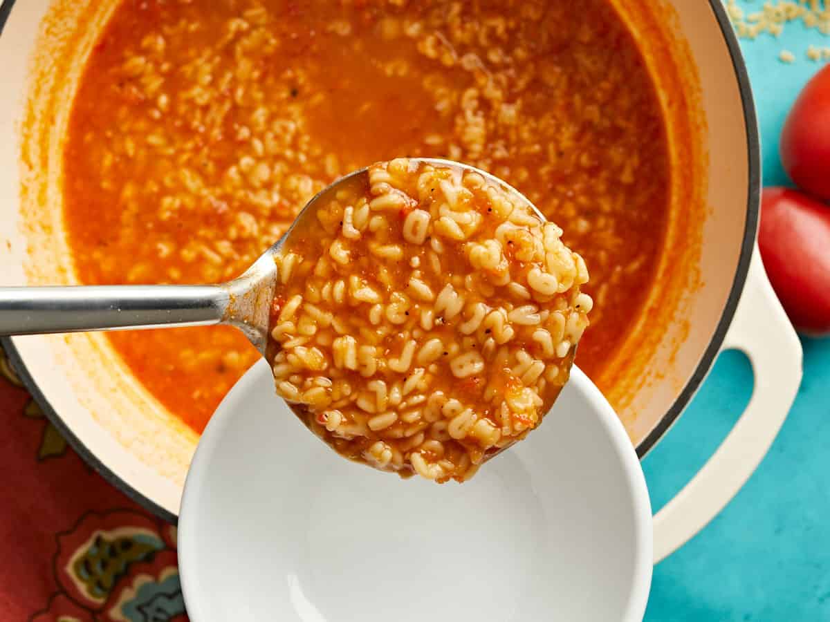 Sopa de letras being ladled into a bowl.