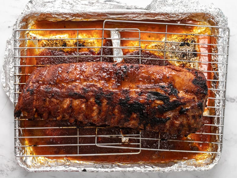 Finished baked ribs on a rack.