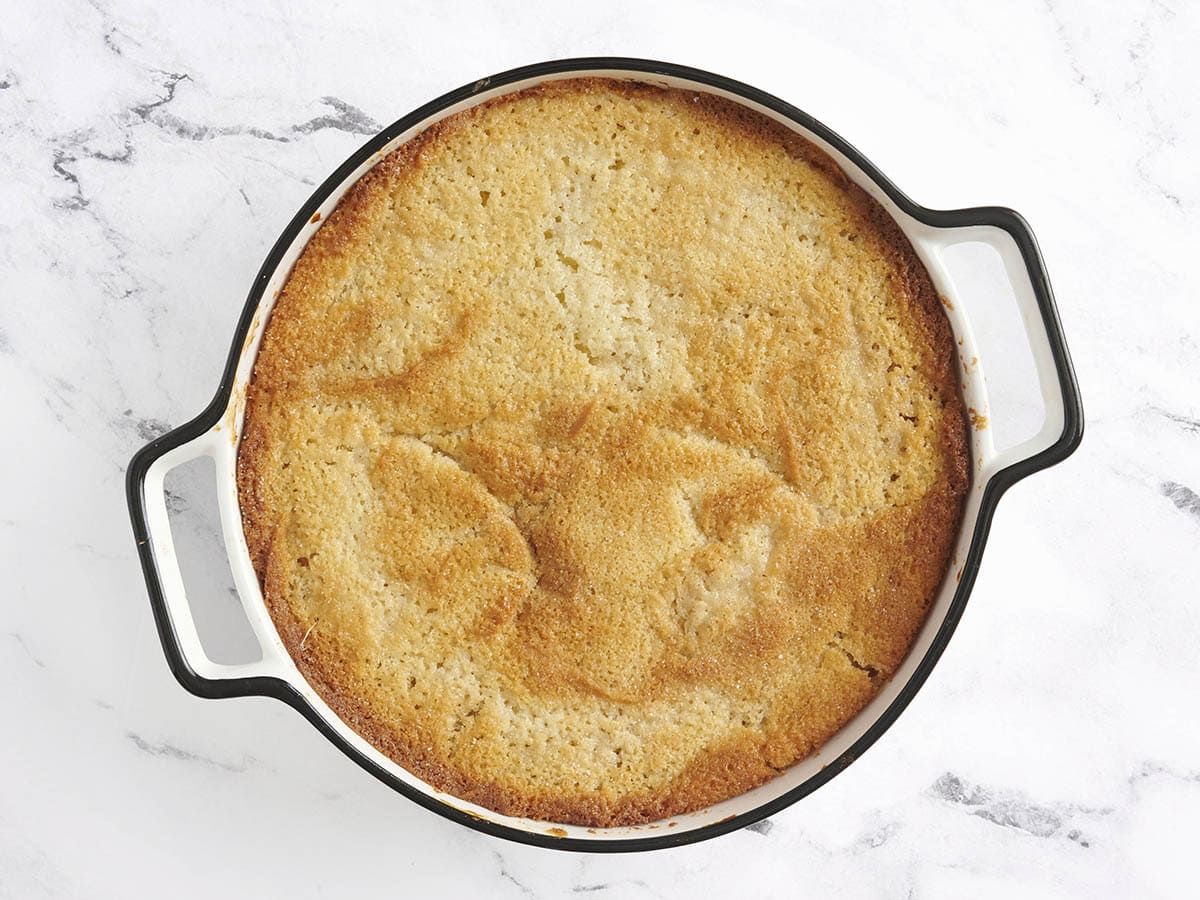 Overhead view of a finished peach cobbler in an oven dish.
