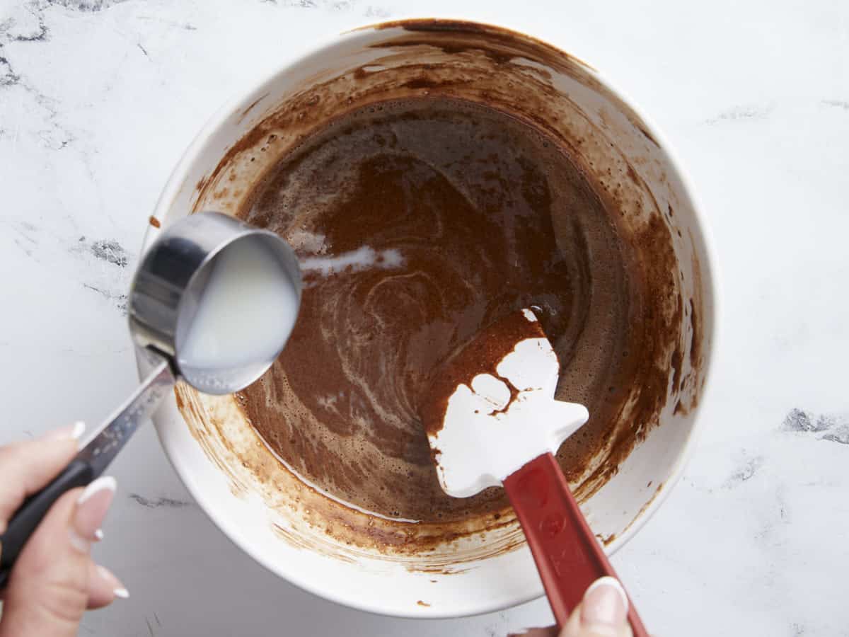 Milk being added to the chocolate mixture.