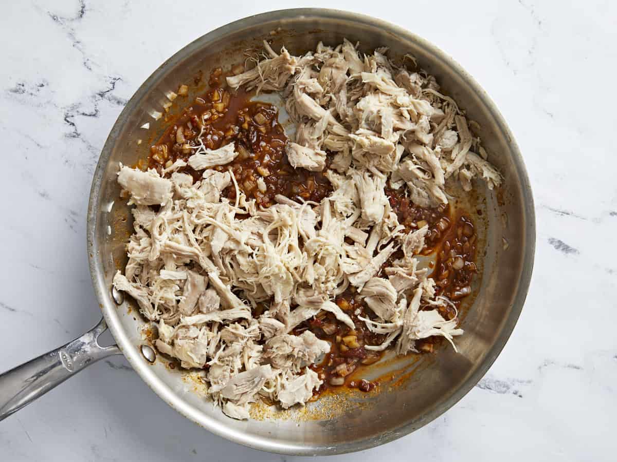 Pulled chicken added to the skillet with the chipotles.