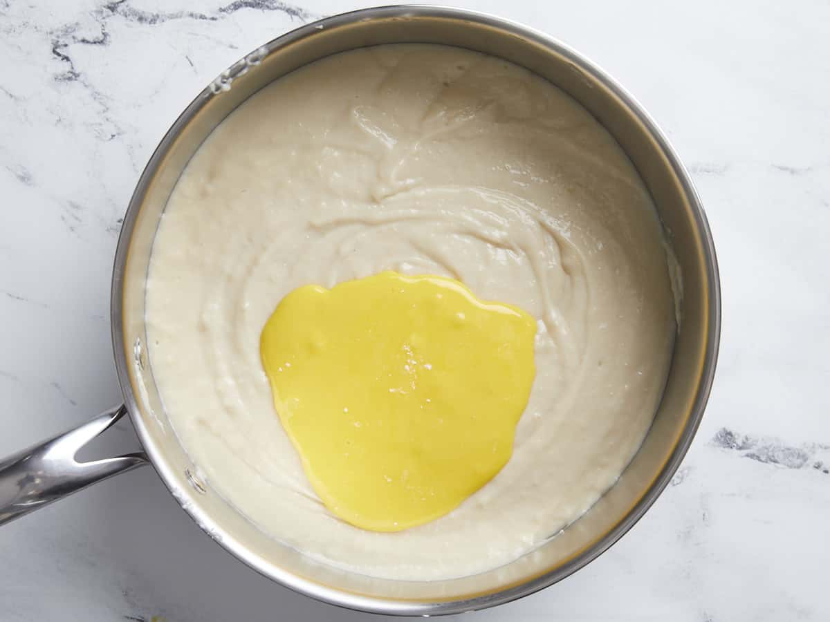 Add egg yolk slurry to custard.