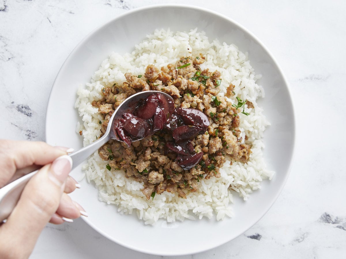 Cherry pork rice bowl being assembled.