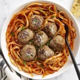 Overhead view of a bowl full of spaghetti with turkey meatballs on top.