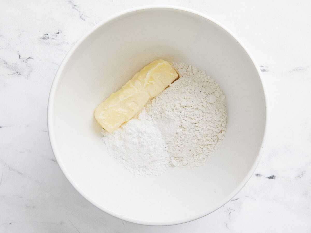 Shortbread crust ingredients in a small white bowl.