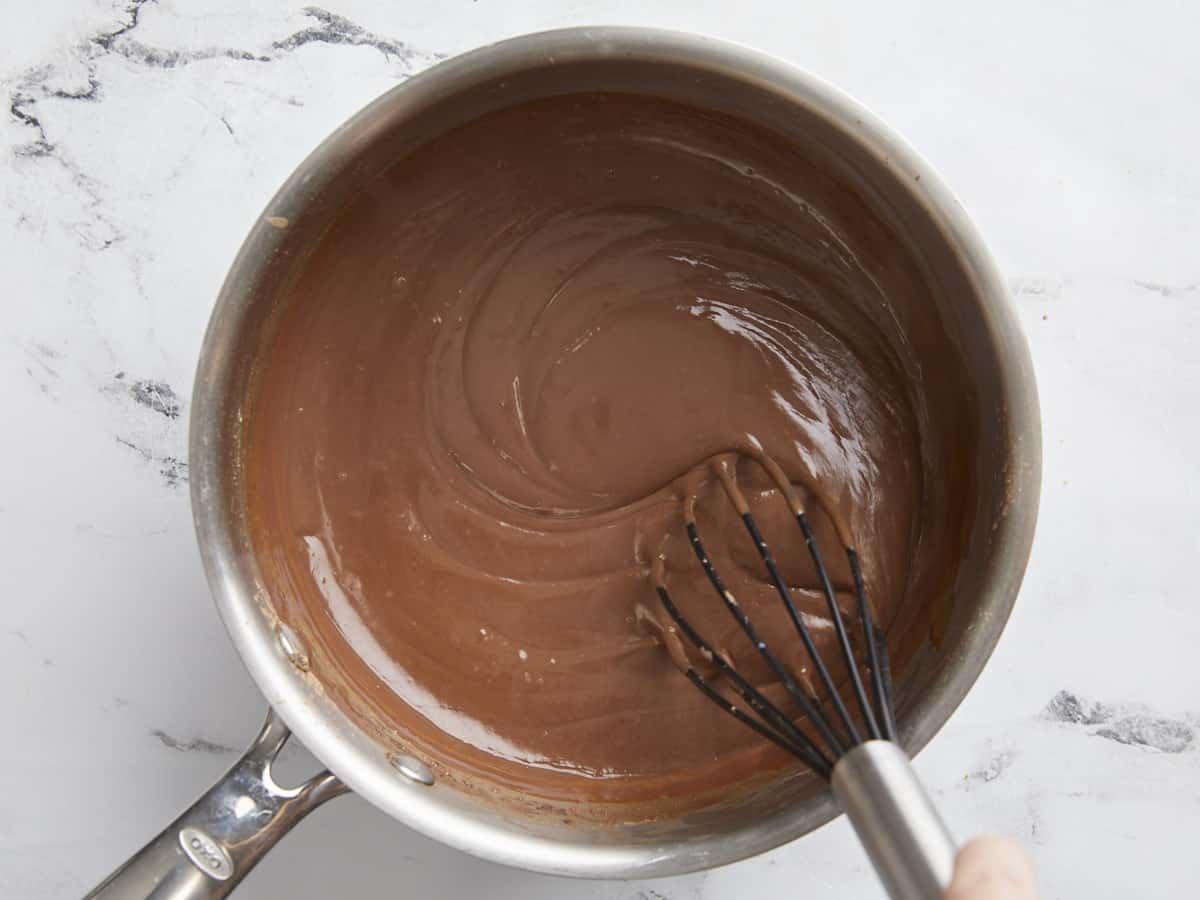 Thickened pudding being whisked.