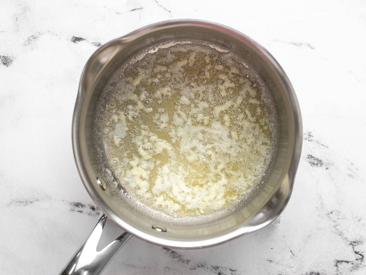 Melted butter and garlic in a saucepot.