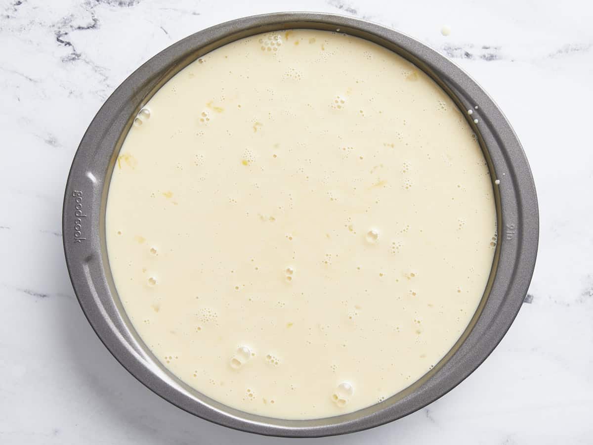Milk mixture poured into a cake pan.