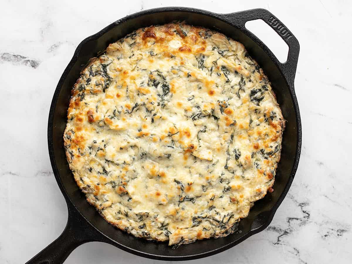 Baked spinach artichoke dip in the skillet.