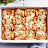 Overhead view of lasagna roll ups in a baking dish.