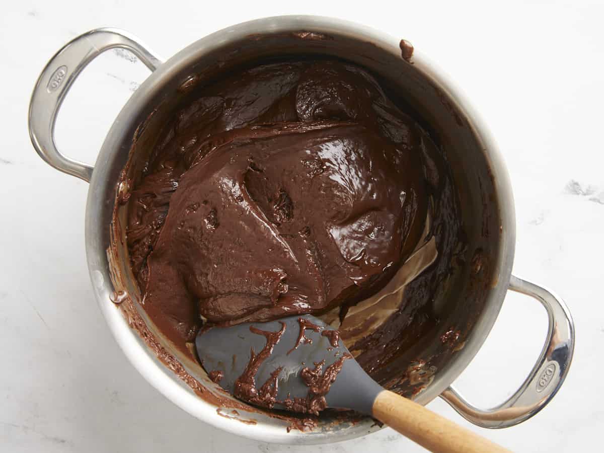 Melted fudge being stirred in the sauce pot.
