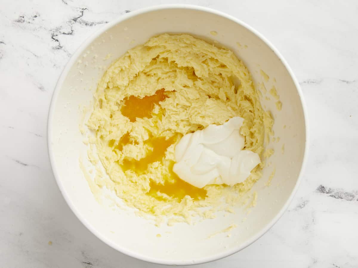 Orange juice and sour cream added to egg, sugar, and butter.