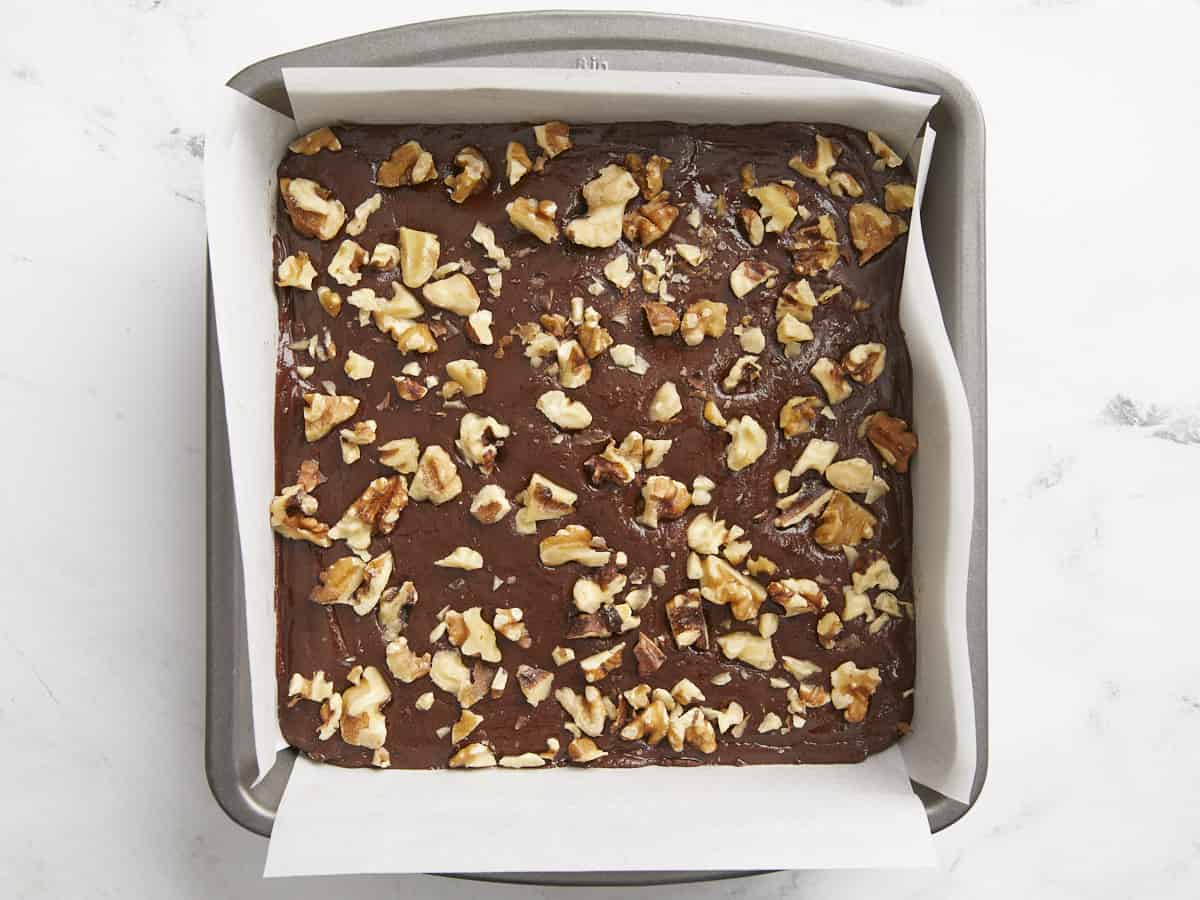 Chopped walnuts pressed into the top of the fudge.
