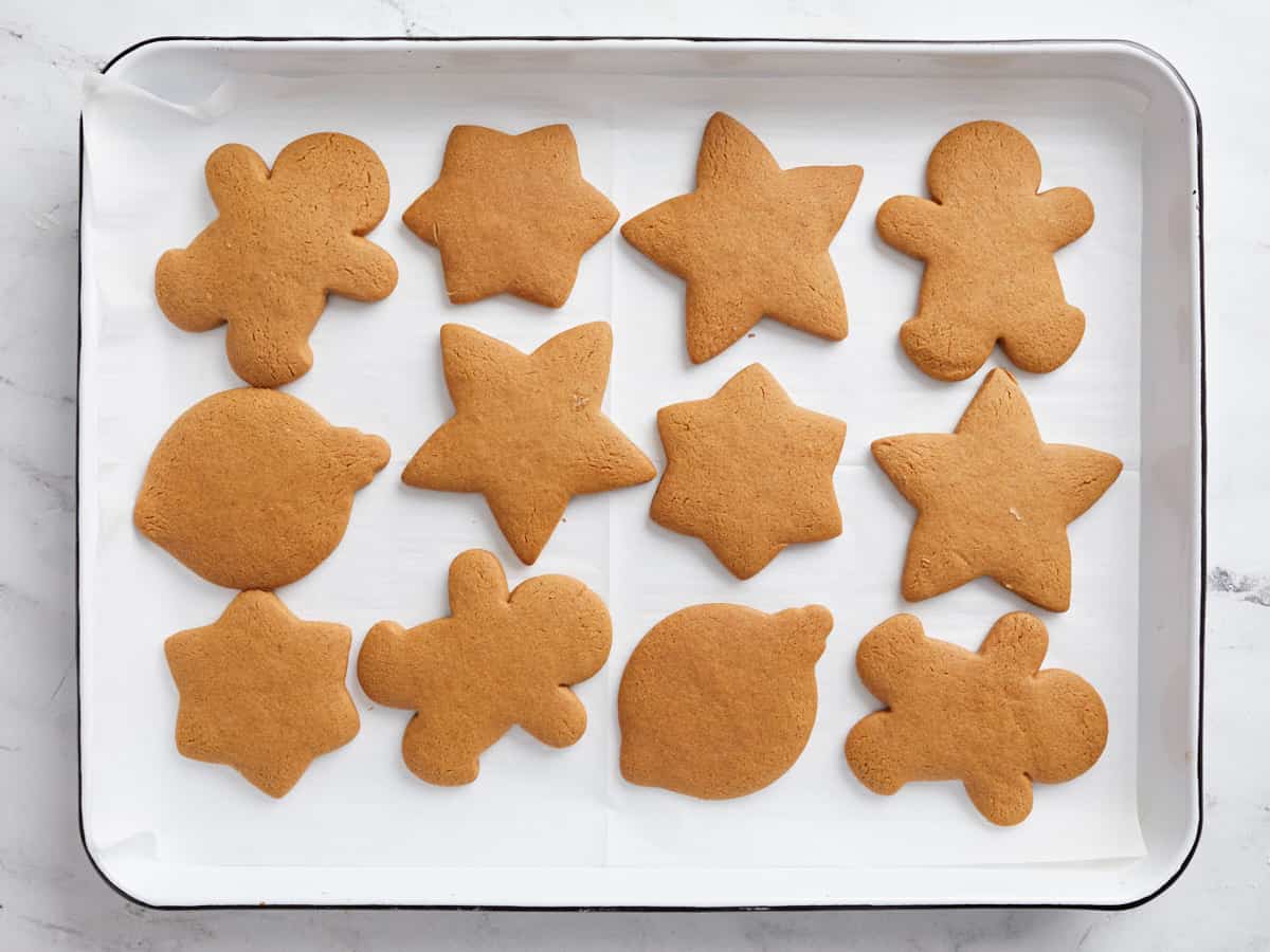 Baked gingerbread cookies on the baking sheet.