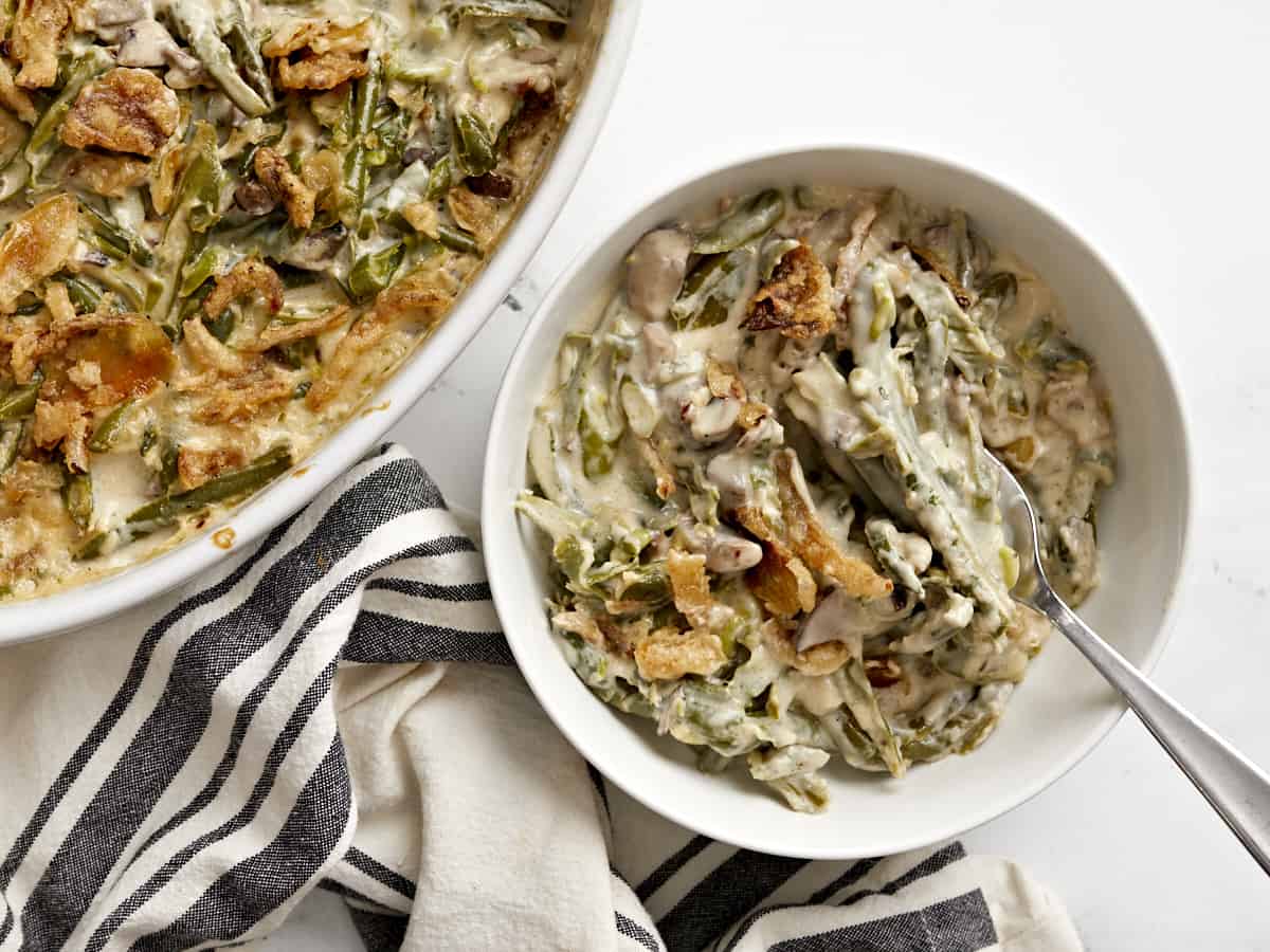 This is the Creamiest Green Bean Casserole you'll ever make with no condensed "cream of" soup. Try this "from scratch" version and taste the difference! Budgetbytes.com Green bean casserole dished out into a bowl with a fork.