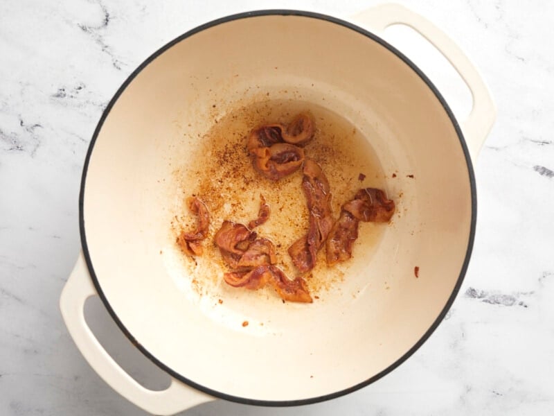 Browned bacon in a Dutch oven.