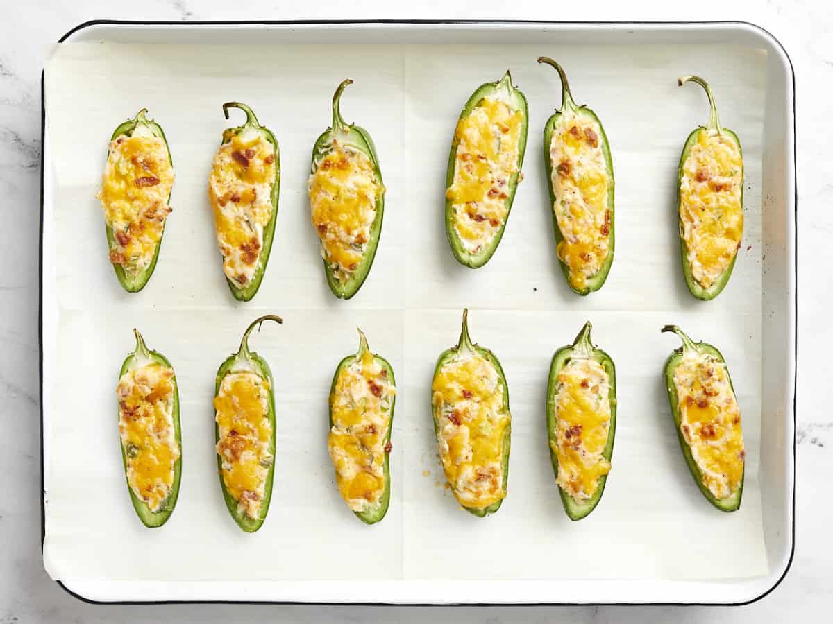 Baked jalapeño poppers on the baking sheet.