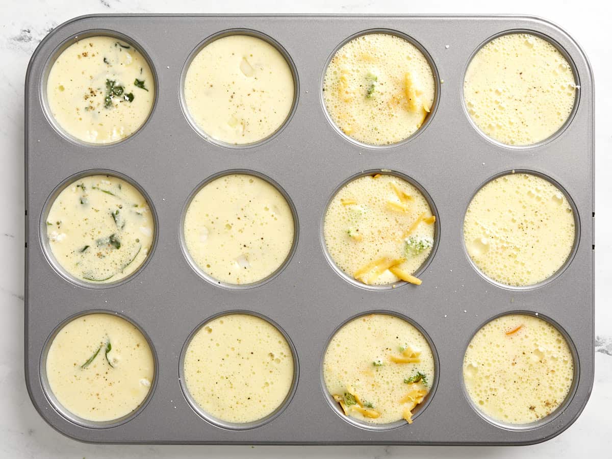 Egg mixture poured into the muffin tin.