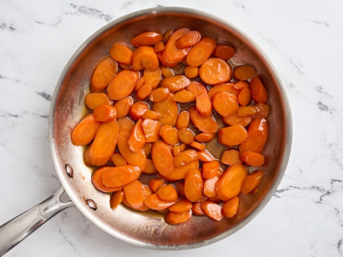 Finished glazed carrots in a pan.