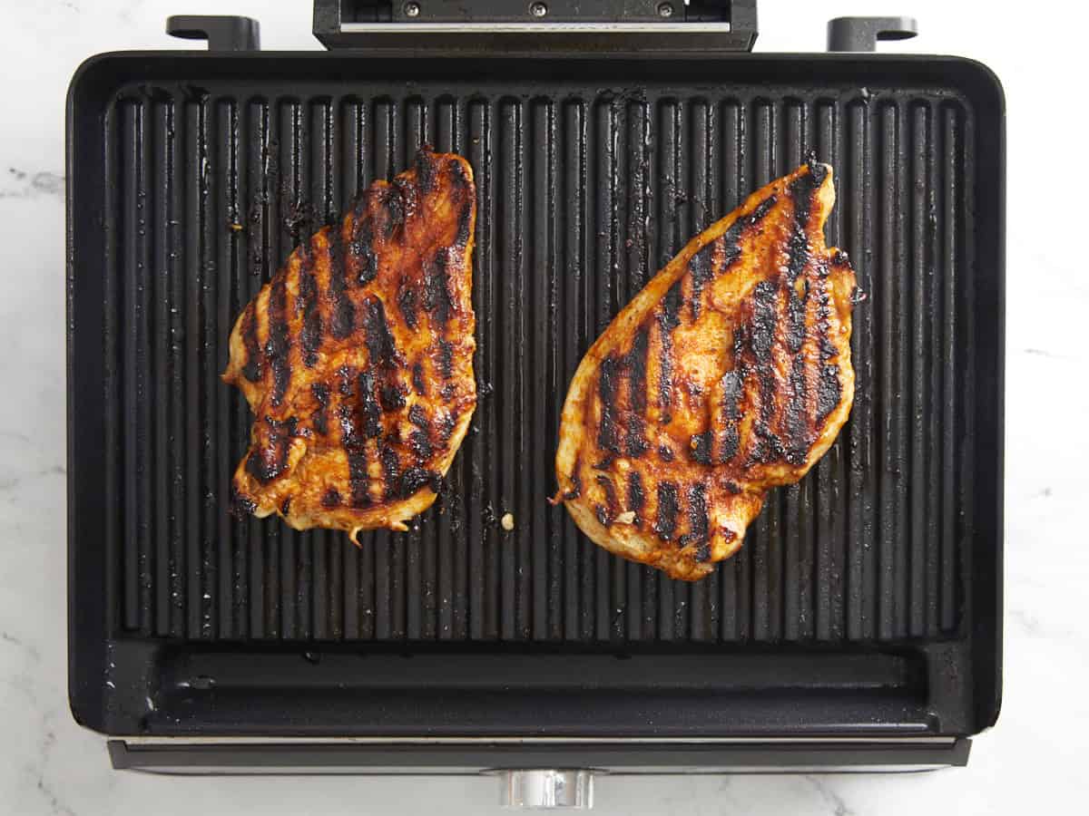 Grilled chicken breasts on an indoor grill.