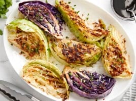Close-up of grilled cabbage wedges on a plate.