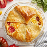 Overhead shot of a delicious tomato pie on a table.