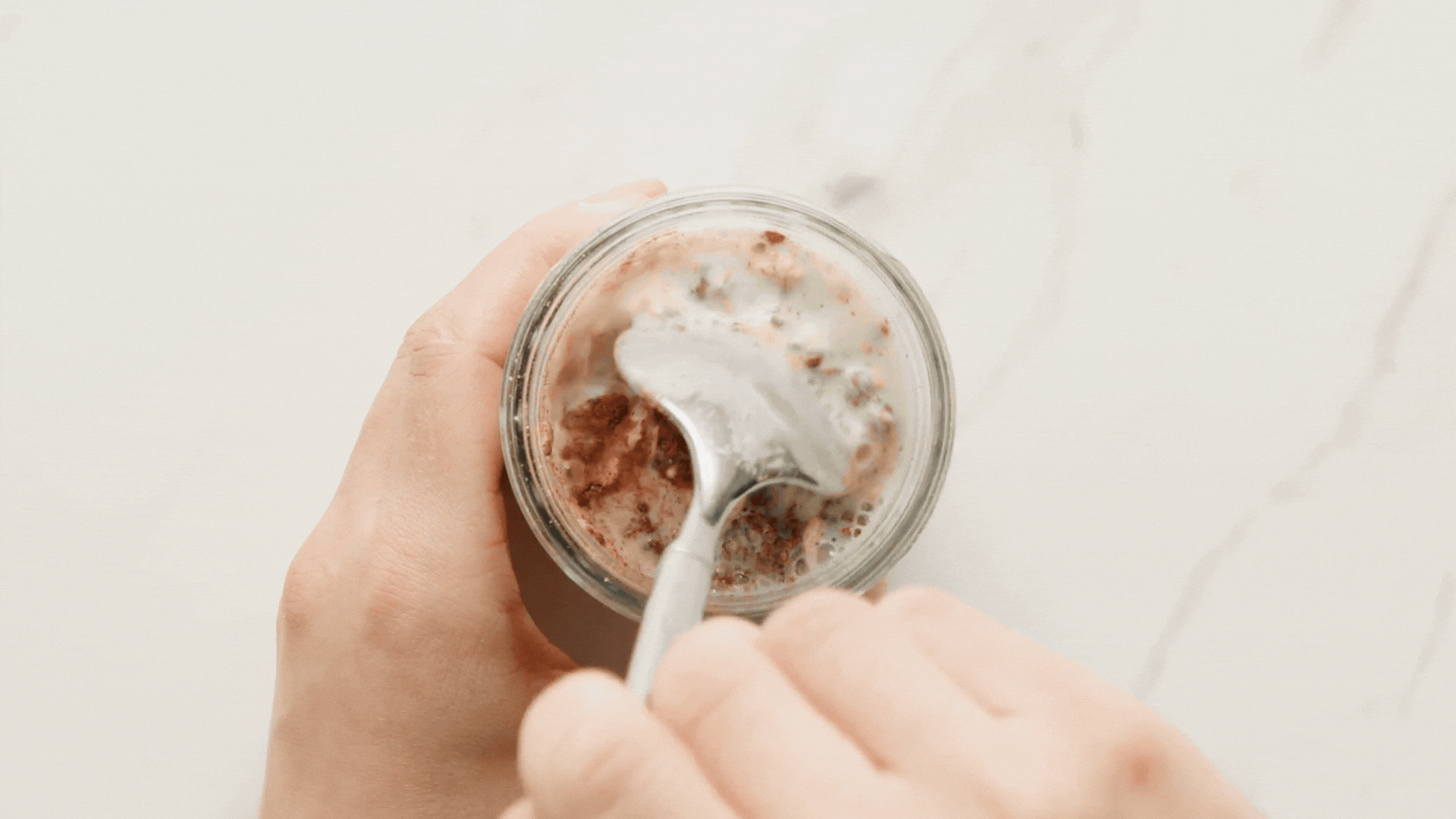 screwing a mason jar onto overnight oats